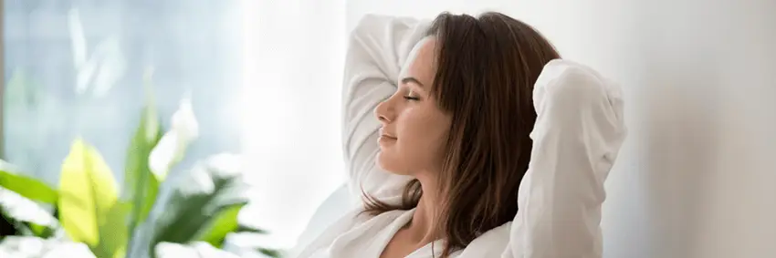 Woman closed eyes put hands behind head relaxing