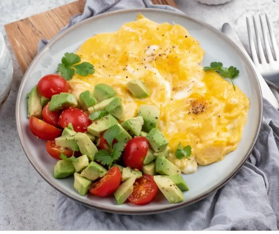 Scrambled eggs with avocado and cherry tomatoes