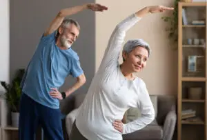 Image of Senior couple doing tai-chi gentle workout at home