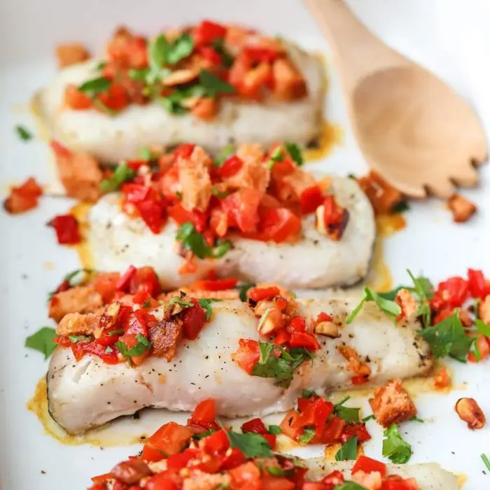 Baked cod fillets topped with romesco salsa